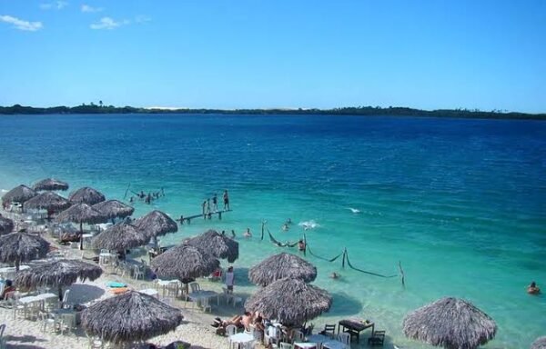 Foto com as barracas da Lagoa Azul em primeiro plano e as águas azuis da Lagoa ao fundo.